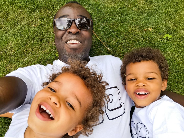 Palmer thinks it's better for kids to be conscious, even vaguely, about their race, so that they aren't left defenceless at school. (Pictured: Casey Palmer and his two sons)