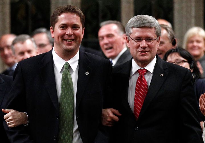 Andrew Scheer and Stephen Harper link arms in Ottawa on June 2, 2011, when Harper was still prime minister.