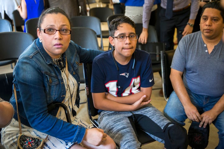 BOSTON, MA - AUGUST 26: Mariela Sanchez of Tegucigalpa, Honduras, left, her son Jonathan Sanchez, 16, and husband Gary Sanchez prepare for questions from reporters after the press conference on termination of medical deferred action at the Irish International Immigrant Center at 1 State St. in Boston on Aug. 26, 2019. Mariela's son, Jonathan, 16, has cystic fibrosis. 