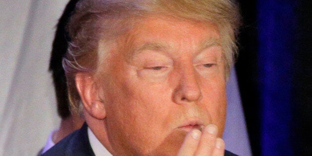 Republican presidential candidate, businessman Donald Trump blows a kiss after speaking at his caucus...