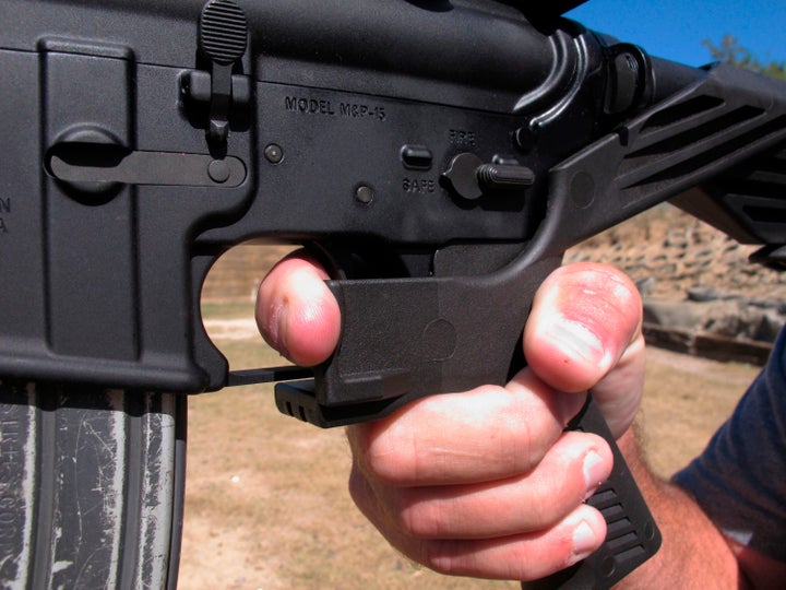 In this Oct. 4, 2017 file photo, a shooting instructor demonstrates the grip on an AR-15 rifle fitted with a "bump stock" at