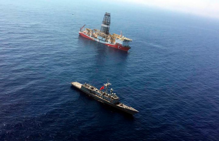 FILE - In this Tuesday, July 9, 2019 file photo, a Turkish Navy warship patrols near Turkey's drilling ship ' Fatih ' that is making its way towards the eastern Mediterranean near Cyprus. Turkish officials say the drillships Fatih and Yavuz will drill for gas, which has prompted protests from Cyprus. (Turkish Defence Ministry via AP, Pool)