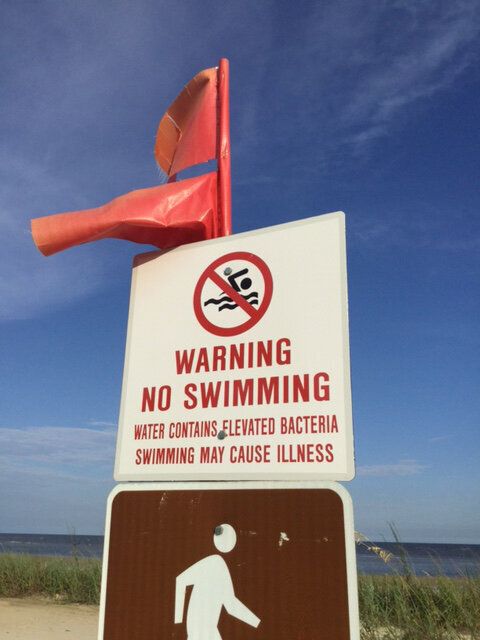 A sign at a beach in Waveland warns against swimming due to algae blooms along the MIssissippi coast.