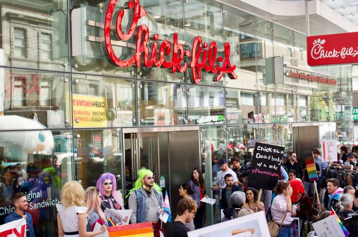 Protesters swarmed the area outside Chick-fil-A as customers lined up along Yonge St. for lunch.