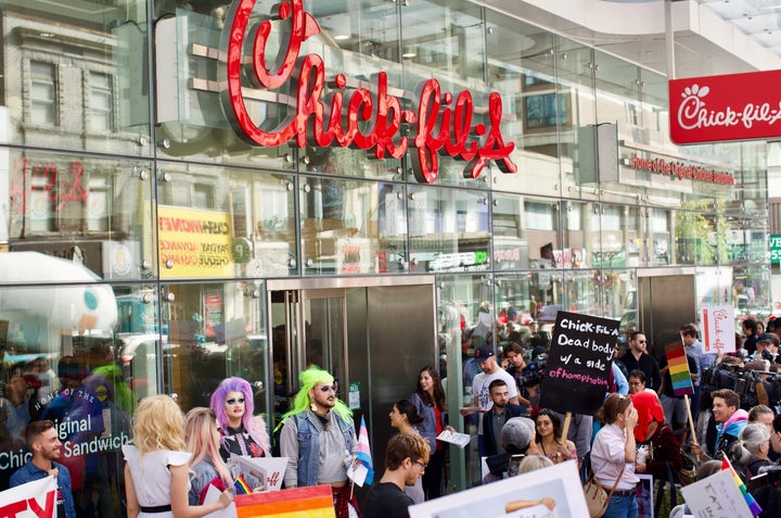 Protesters swarmed the area outside Chick-fil-A as customers lined up along Yonge St. for lunch.