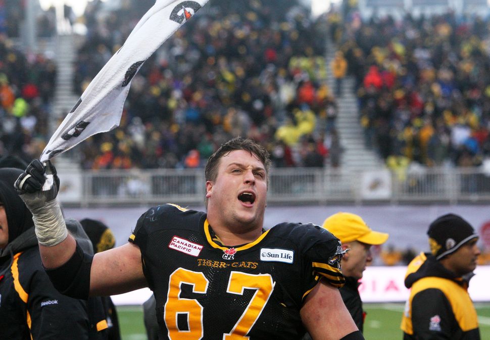 Peter Dyakowski gets the crowd going during the CFL Eastern semi-final in Guelph on Nov. 10, 2013. 