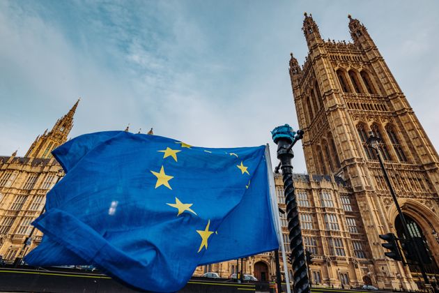 A stock image of a European flag outside the Houses of Parliament. 