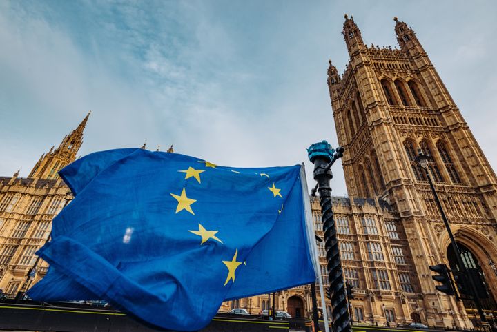 A stock image of a European flag outside the Houses of Parliament. 