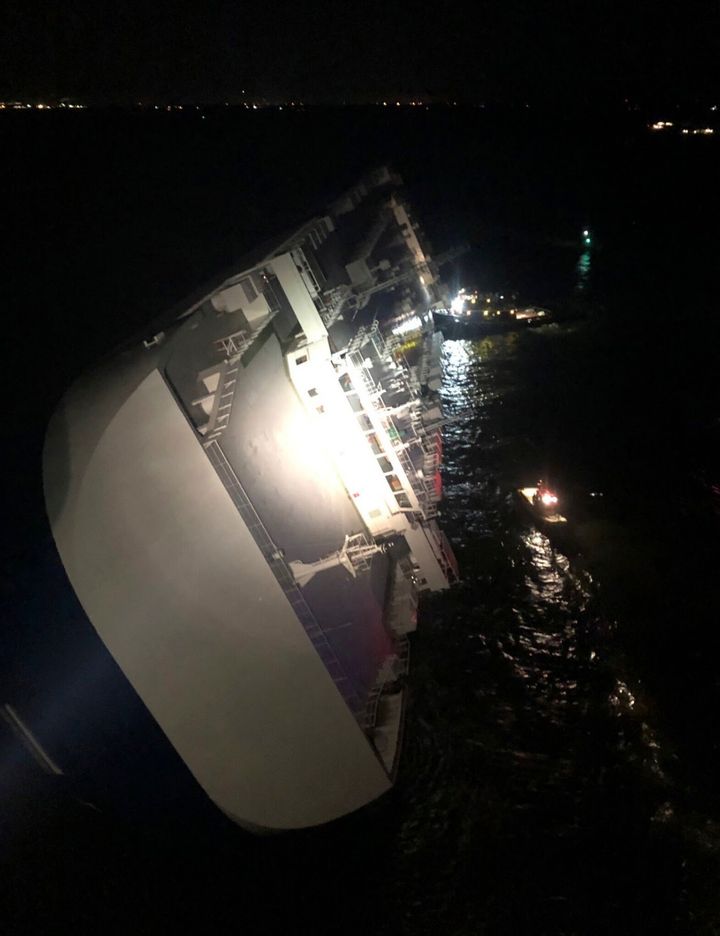 In this photo provided by the U.S. Coast Guard, the Golden Ray cargo ship lists to one side near a port on the Georgia coast, early Sunday, Sept. 8, 2019.