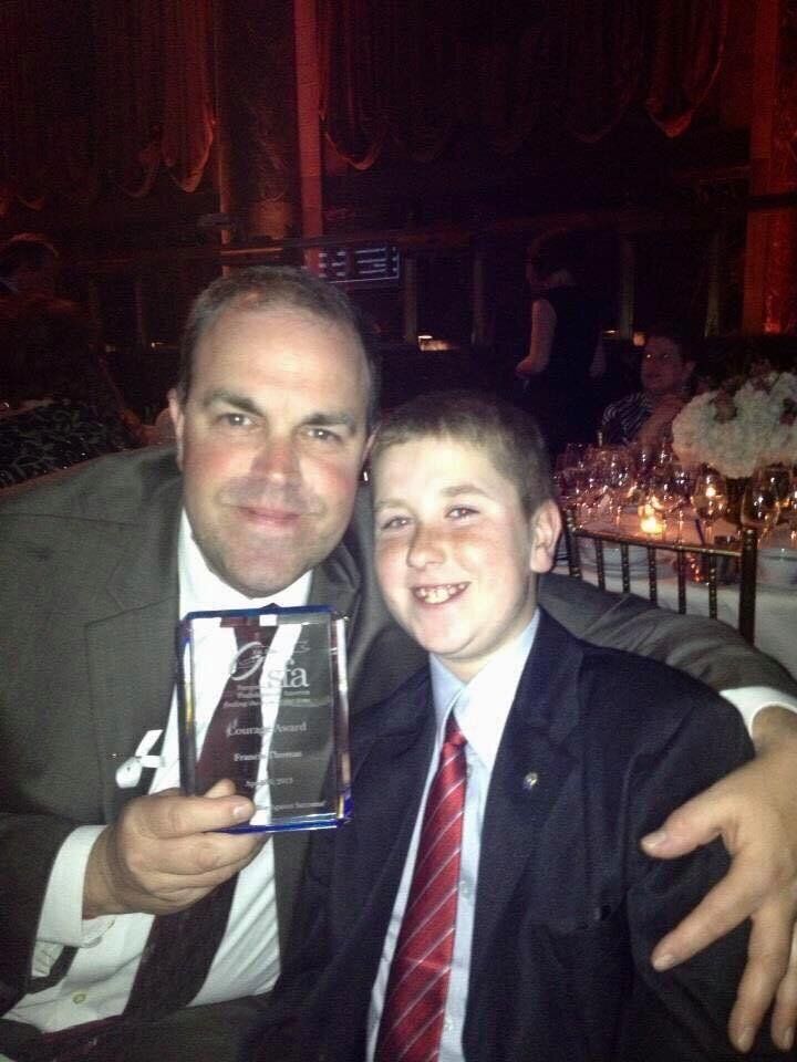 Thomas's dad, with her younger brother, at a ceremony where he received the Courage Award from the Sarcoma Foundation of America in 2013. 