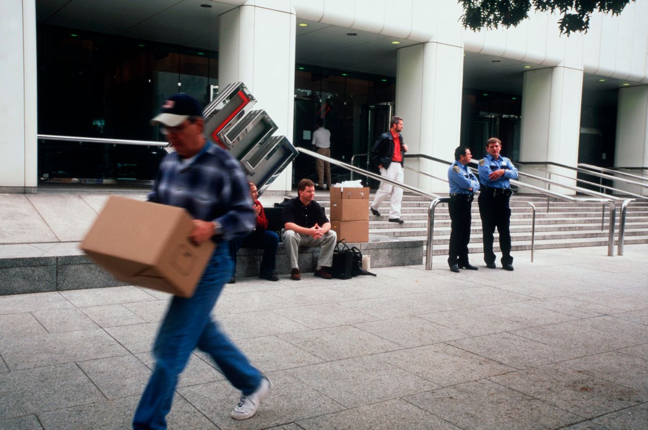 Employees remove their belongings from Enron's corporate headquarters after being laid off due to the company's collapse.