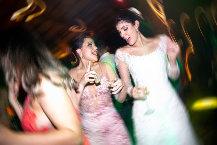 Bride and wedding guest dancing during a wedding reception.