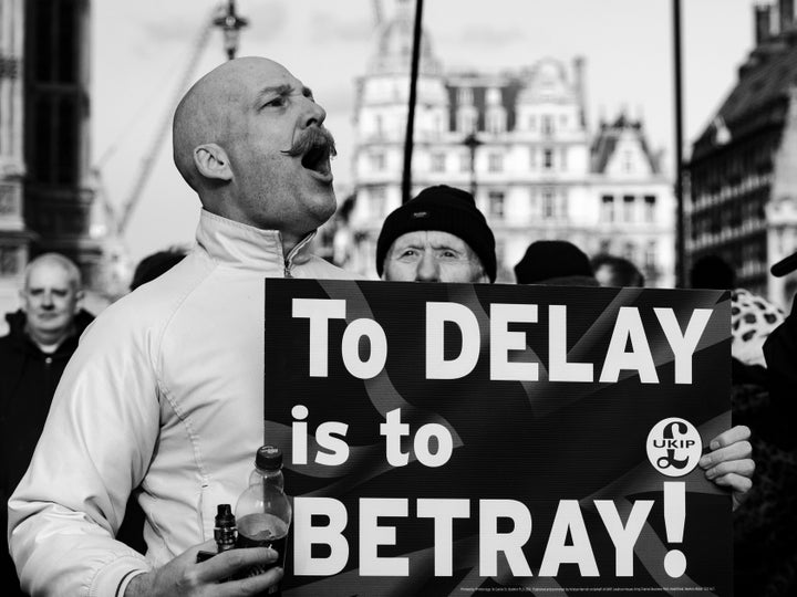 "A pro-Brexit supporter sings outside Parliament."