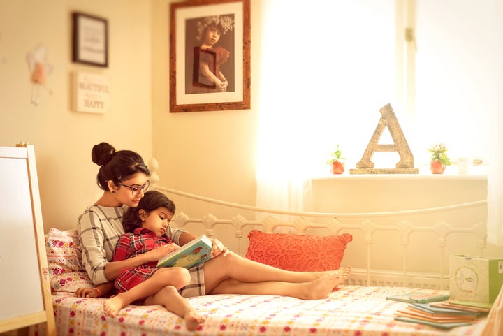 "A self portrait of me reading a story to my daughter on a summer afternoon."