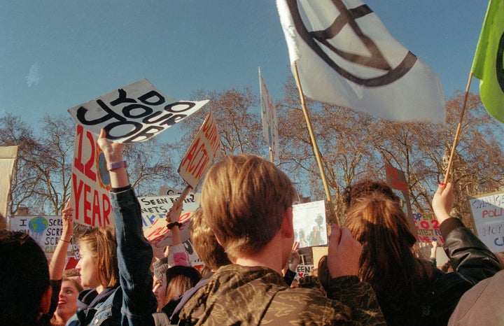 "Children standing together outside parliament on a climate youth strike."