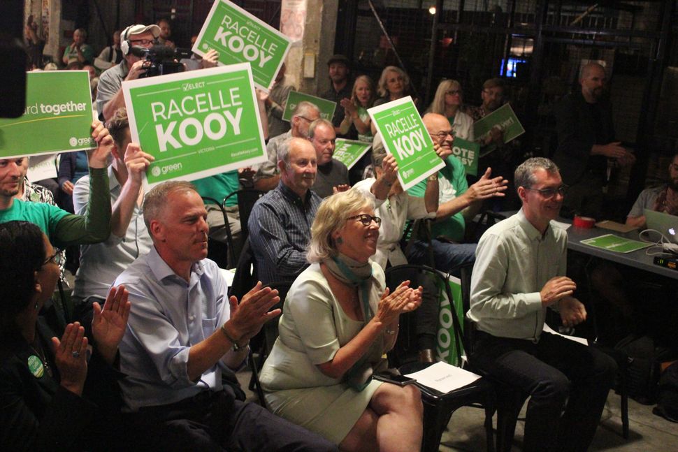 Green Party leader Elizabeth May sits with candidates at a rally in Victoria. 