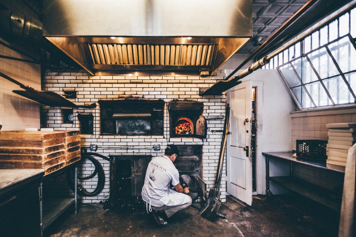 The pizza makers at Pepe's in New Haven use a coal-fired oven.