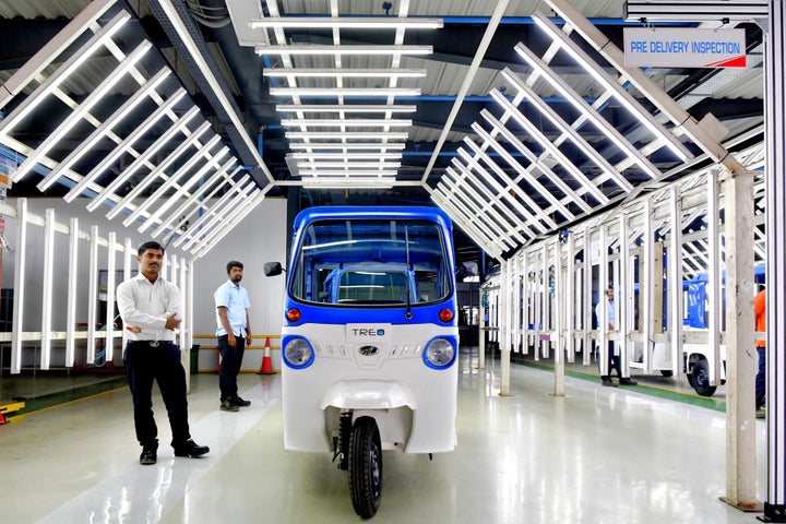 A Treo auto-rickshaw, Mahindra Electric's first lithium ion battery-powered three-wheeler, stands following rollout at an inspection bay during the inauguration of Mahindra's Electric Technology Manufacturing Hub in Karnataka, on November 15, 2018.