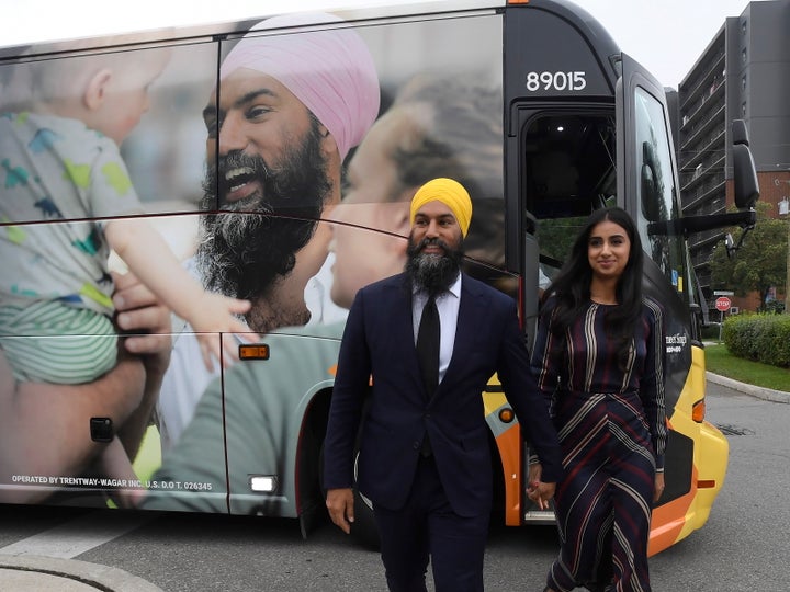 NDP Leader Jagmeet Singh and his wife Gurkiran Kaur Sidhu stand by his campaign bus in London, Ont., on Sept.11, 2019.