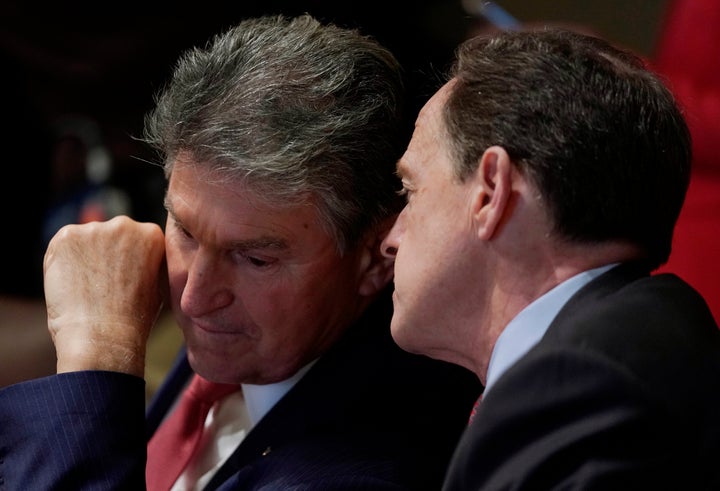 Sen. Joe Manchin (D-W.Va.), left, and Sen. Pat Toomey (R-Pa.) confer as President Donald Trump discusses school and community safety after the Feb. 14, 2018, massacre in Parkland, Florida. The senators are among a bipartisan group talking again with the president about possible gun control legislation.