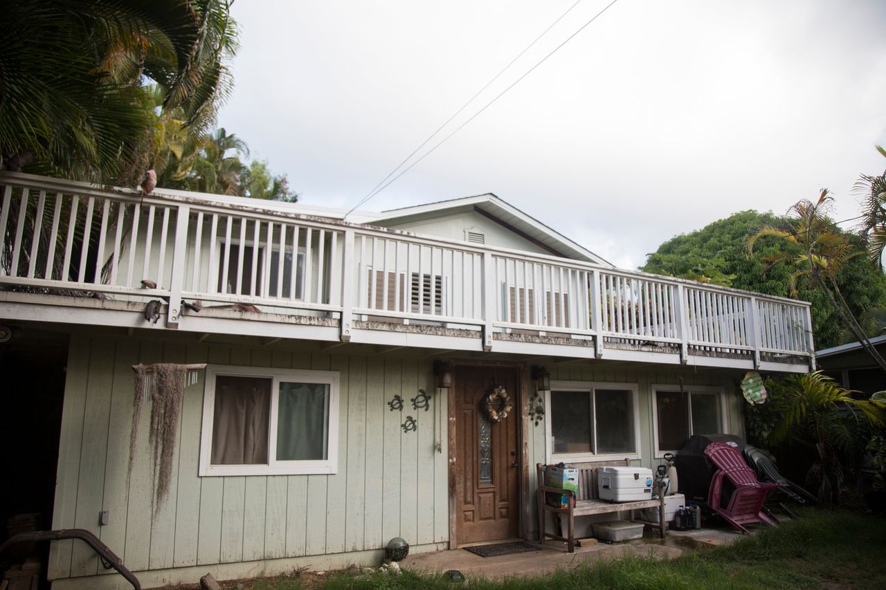 The exterior of the Manuwai family's Kailua, Hawai'i, home. After dealing with a bad contractor, they were left with an unfinished house. To this day, there is no door to the outside deck.