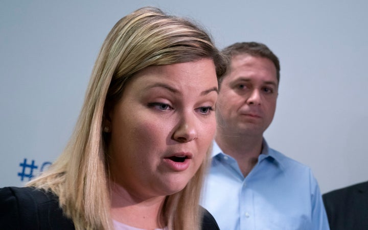 Conservative candidate for York Centre Rachel Willson responds to questions from reporters as leader Andrew Scheer looks on while visiting a daycare in Toronto on Sept. 12, 2019.