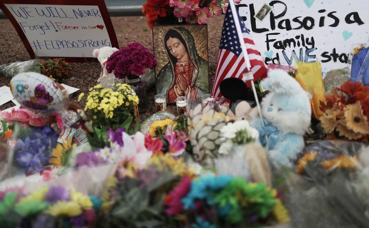 EL PASO, TEXAS - AUGUST 04: Flowers and mementos are seen at a makeshift memorial outside Walmart, near the scene of a mass shooting which left at least 20 people dead, on August 4, 2019 in El Paso, Texas. A 21-year-old male suspect was taken into custody in the city which sits along the U.S.-Mexico border. At least 26 people were wounded. (Photo by Mario Tama/Getty Images)