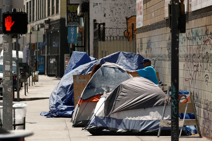 Tents and tarps erected by homeless people are shown along sidewalks and streets in the skid row area of downtown Los Angeles
