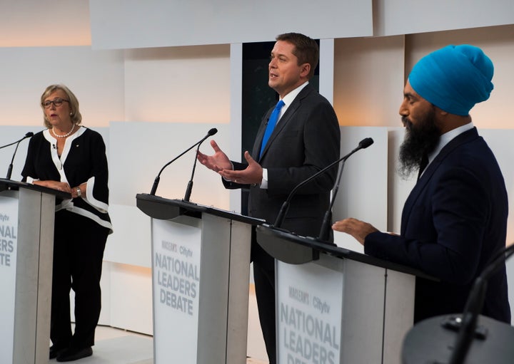 Conservative Leader Andrew Scheer, centre, speaks as Green Party Leader Elizabeth May and NDP Leader Jagmeet Singh listen during the Maclean's/Citytv National Leaders Debate in Toronto on Sept. 12, 2019.