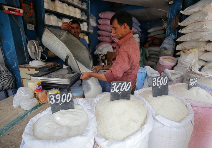 A man packs sugar for sale inside a shop at a marketplace in Ahmedabad, India, September 19, 2018.