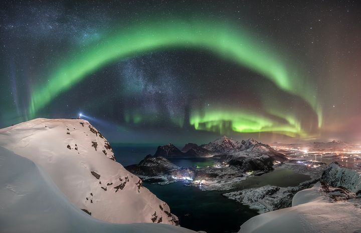 The Watcher by Nicolai Brügger.The photographer hiked in the snow to the top of the mountain Offersøykammen in Norway to witness and capture the breathtaking giant aurora over the Lofoten Islands. He waited many hours and after midnight, the bright Northern Lights finally appeared. 