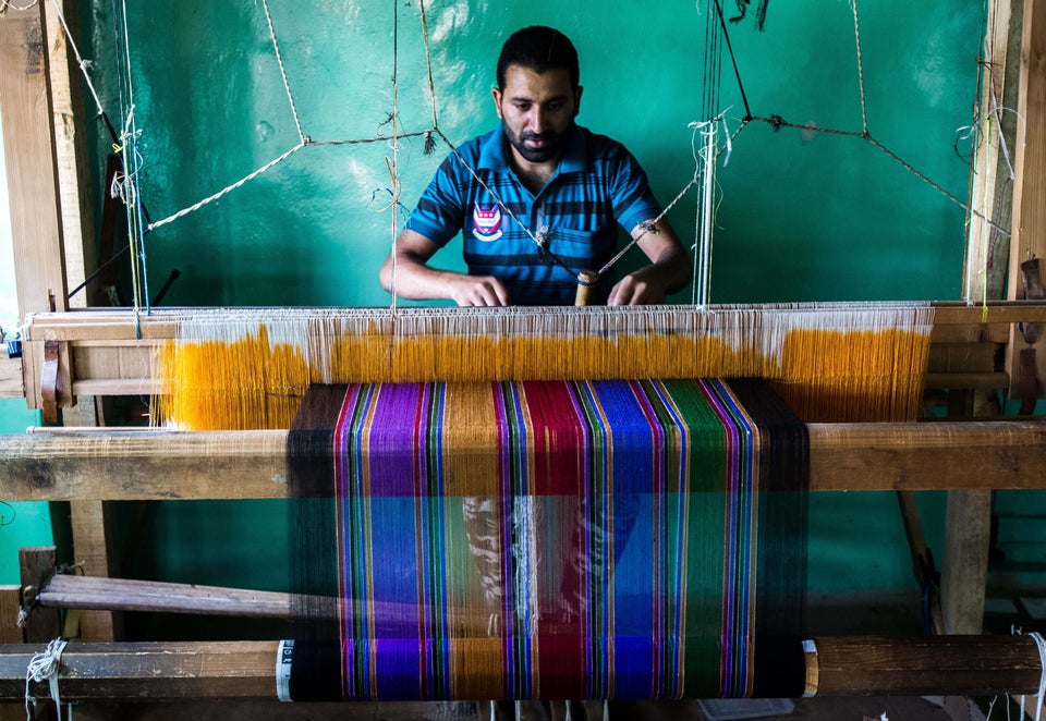 A Kashmiri artisan weaves pashmina shawl in outskirts of Srinagar on Sept. 17,