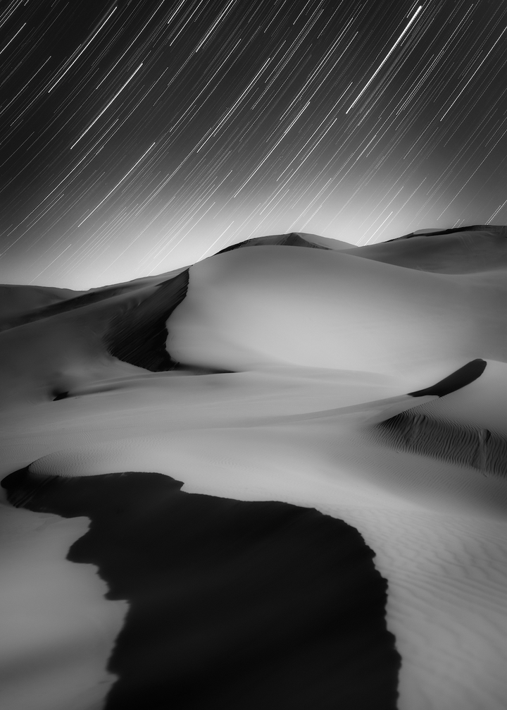 Sky and Ground, Stars and Sand, by Shuchang Dong.The Moon was shining bright over the sand dunes in north-central China, when the photographer decided to capture this image with a friend. After enjoying a sunset and the rise of the Moon, they began to take photos of the magnificent starry sky.