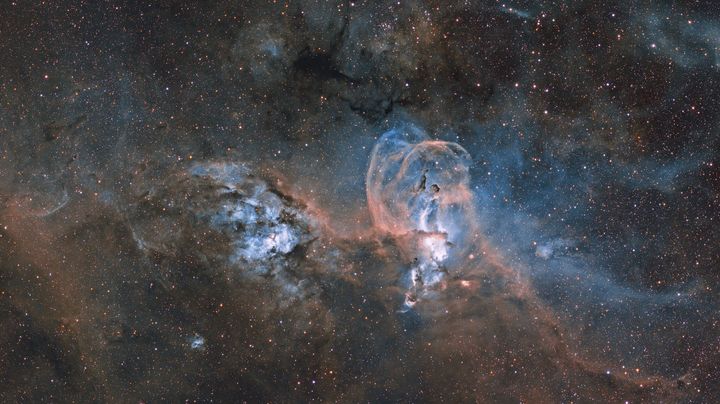 Statue of Liberty Nebula, by Ignacio Diaz Bobillo.These are two nebula complexes, far apart from one another. The one on the right, NGC 3576, is closer to Earth, and its shape provides the title of this image. 
