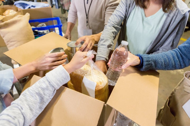 Food bank volunteers sort through donated food items.