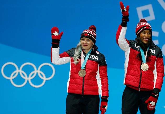 Bronze medalists Kaillie Humphries and Phylicia George of Canada wave from the podium at the Pyeongchang Winter Olympics on Feb. 22, 2018. 