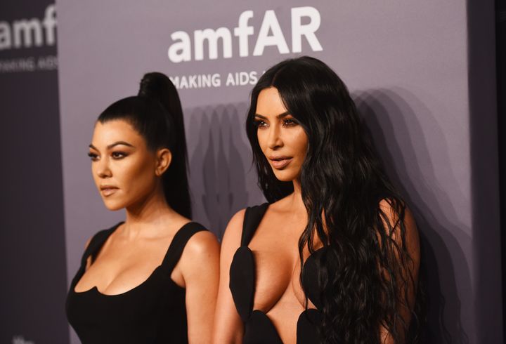 Kourtney Kardashian and Kim Kardashian attend the amfAR New York Gala.