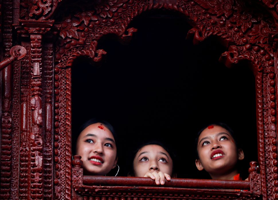 Η πρώην Θεά της Ζωής Κουμάρι Ματίνα Σάκια κοιτάζει από το παράθυρο ενός σπιτιού Κουμάρι κατά τη διάρκεια του φεστιβάλ Ιντρα Τζάτρα στο Κατμαντού του Νεπάλ, στις 13 Σεπτεμβρίου. Το ετήσιο φεστιβάλ, το όνομά του οποίου προέρχεται από τον Ινδρα, τον θεό της βροχής και του ουρανού, γιορτάζεται με λατρεία, χαρά, τραγούδι, χορό και γλέντι στην κοιλάδα του Κατμαντού για να σηματοδοτήσει το τέλος της εποχής των μουσώνων. Ο Ιντρα, η ζωντανή θεά Κουμάρι και άλλες θεότητες λατρεύονται κατά τη διάρκεια του φεστιβάλ.