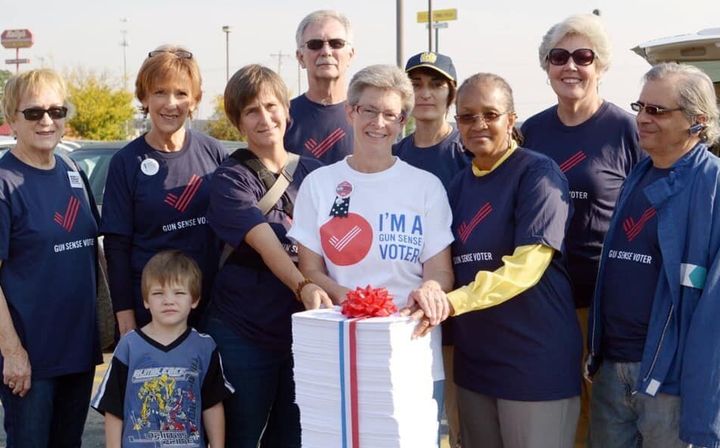 Michele Mueller, center, and other volunteers for Moms Demand Action took a giant stack of petitions to a Kroger in Cincinnati in 2014 to ask the grocery chain to stop allowing open carry.