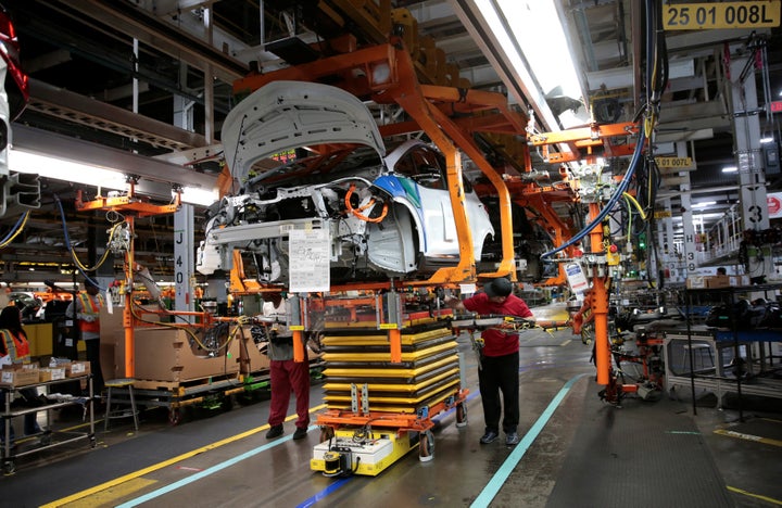 General Motors assembly workers connect a battery pack underneath a partially assembled 2018 Chevrolet Bolt EV. Representational image.