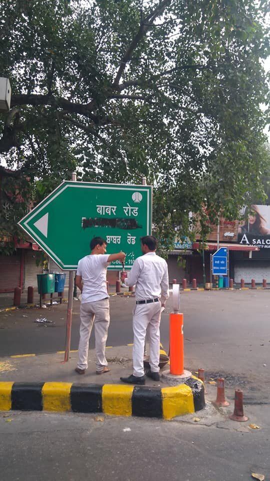 Workers of Hindu Sena today blackened the road signage of 'Babar Road' at Bengali market in New Delhi. 