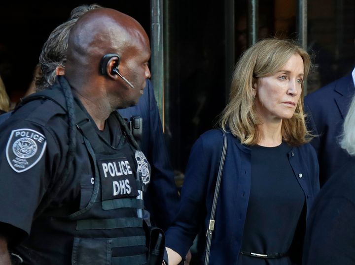 Felicity Huffman leaves federal court after her sentencing in a nationwide college admissions bribery scandal, Friday, Sept. 13, 2019, in Boston. (AP Photo/Elise Amendola)