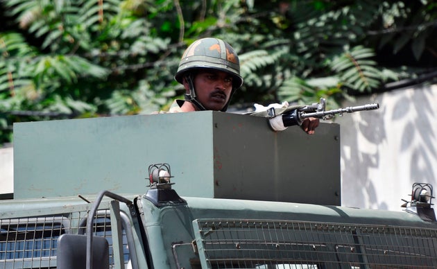 File photo of an Indian army soldier stands alert in a truck while travelling in a convoy in J&K. ...