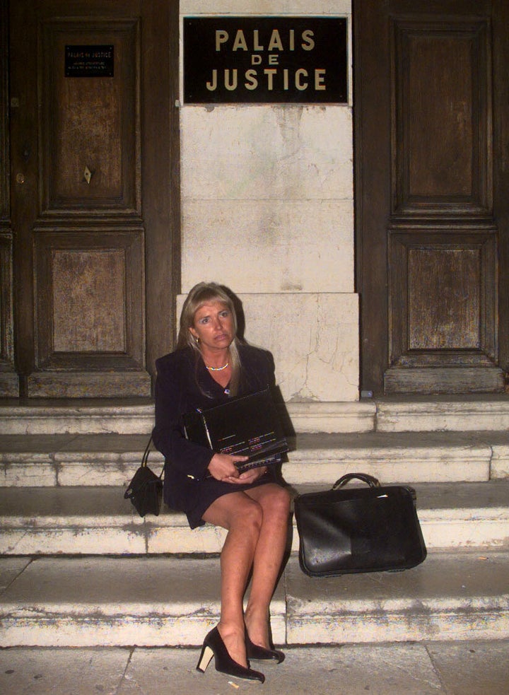 Margaret Moore sits alone on the steps of the Palais de Justice in Grasse, France, during the 1998 hearing.