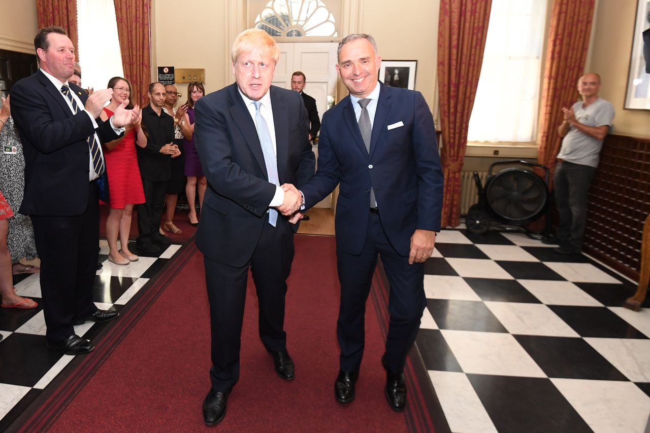 Cummings (far right) as Boris Johnson shakes hands with Cabinet Secretary Sir Mark Sedwill, as he is clapped into 10 Downing Street on his first day.