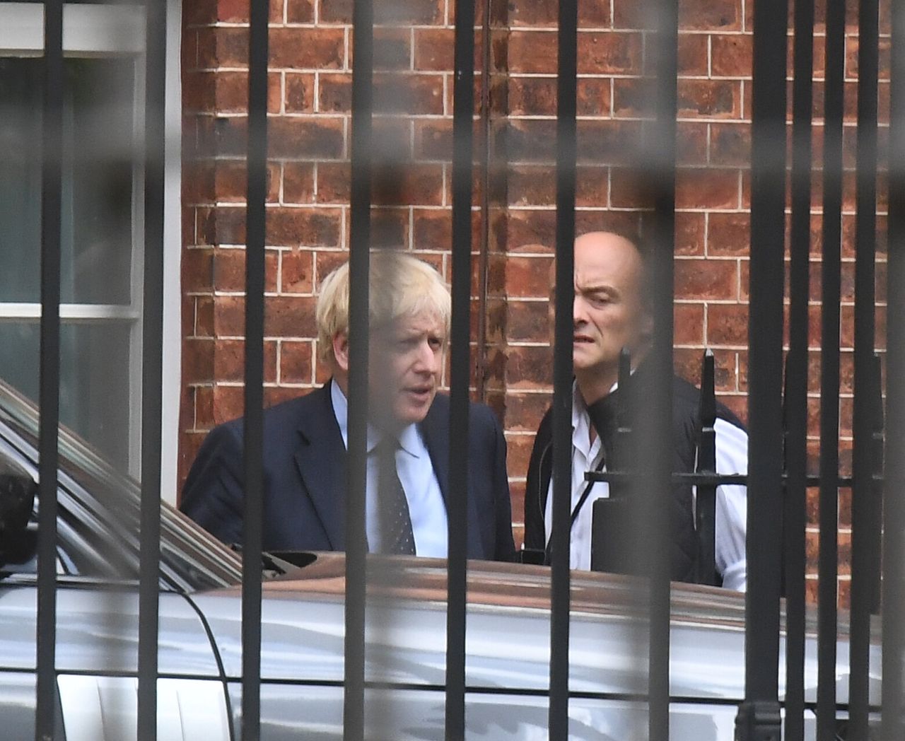 Prime Minister Boris Johnson with his senior aid Dominic Cummings as they leave Downing Street, central London.