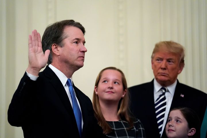 Kavanaugh takes his oath during his ceremonial swearing-in as a Supreme Court justice in October as Trump and Kavanaugh's daughters Liza and Margaret look on.
