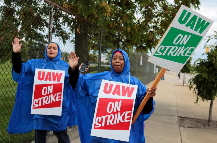 United Auto Workers, Aramark workers, carry strike signs outside the General Motors Detroit-Hamtramck assembly plant in Detroit, Michigan, on Sunday.