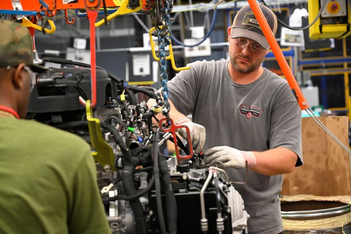 Workers assemble engines as they make their way through the assembly line at the General Motors manufacturing plant in Spring Hill, Tennessee, on Aug. 22.