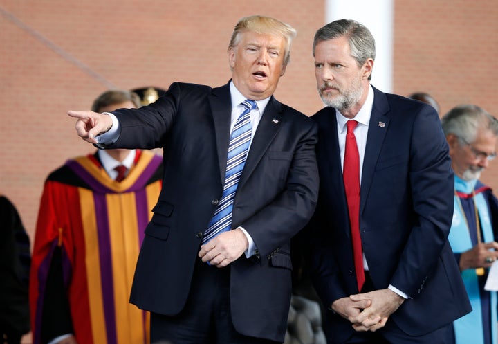 President Donald Trump speaks with Jerry Falwell Jr. during commencement ceremonies at Liberty University in Lynchburg, Virgi